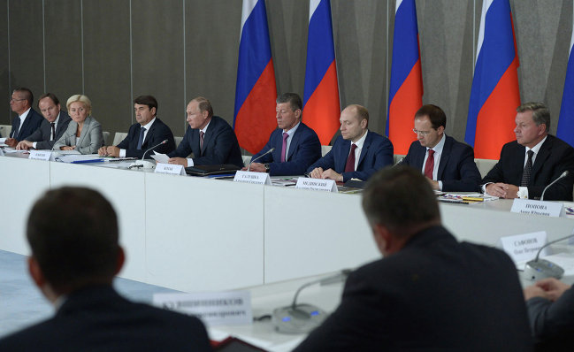 Russian President Vladimir Putin, background, center, holds a meeting of the State Council's Presidium on tourism development in Crimea